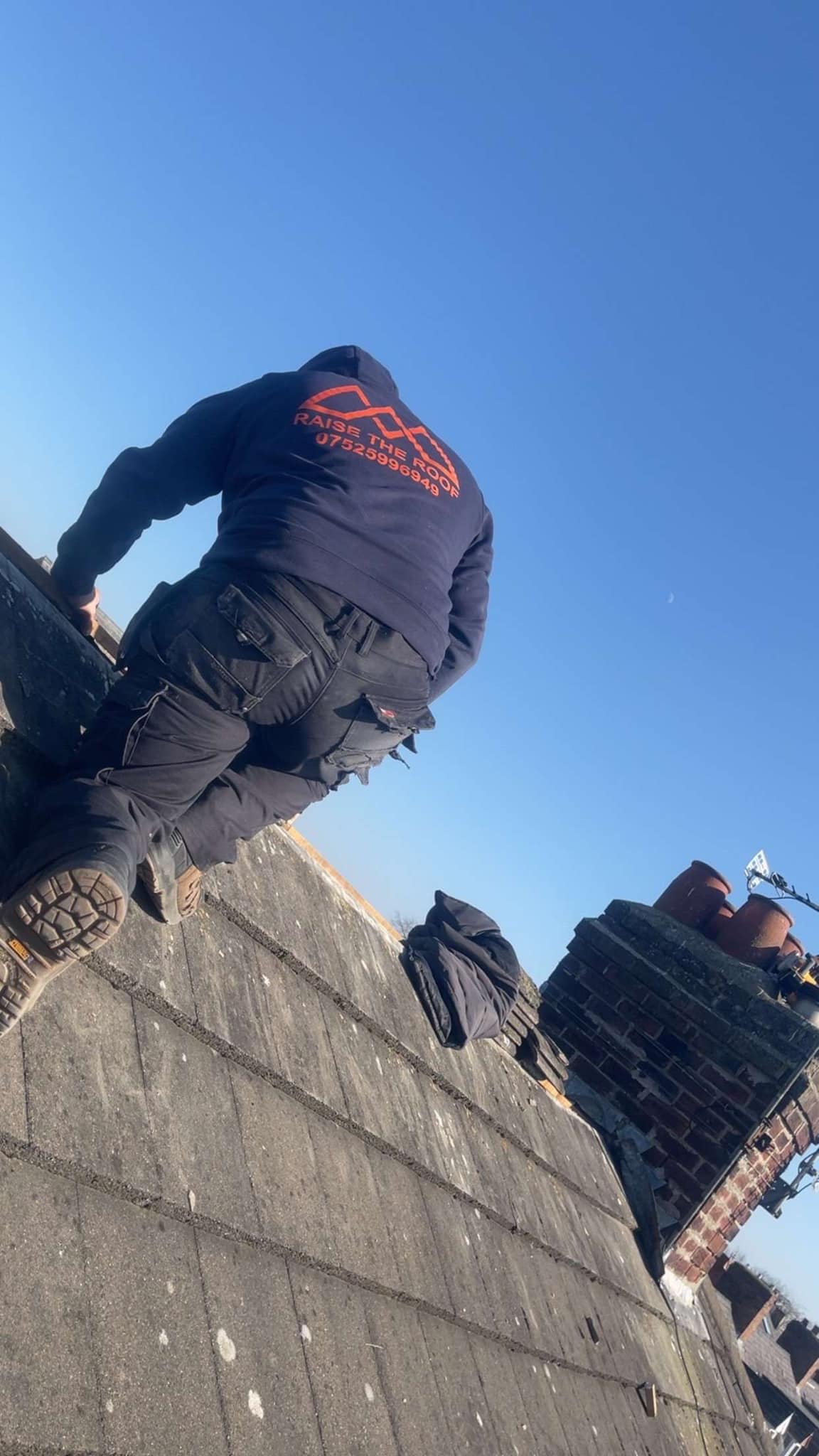 Roofing technician inspecting tiles